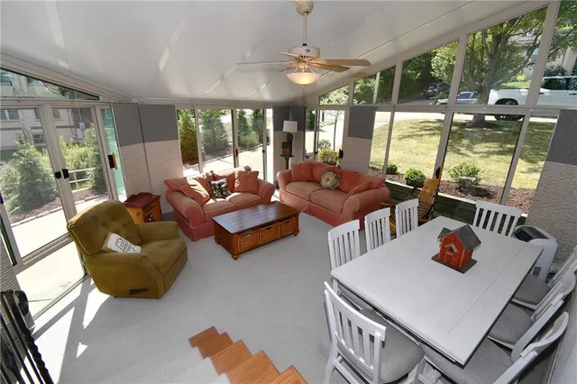 a living room with furniture a chandelier and a dining table