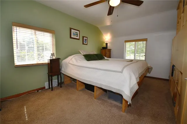 a bedroom with a bed couch and a window