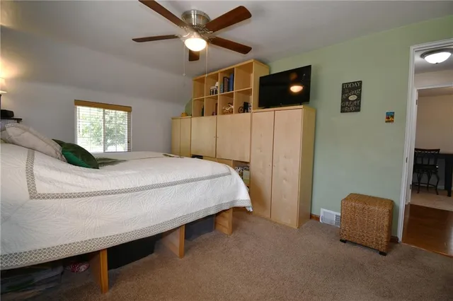 a bed sitting in a bedroom next to a window