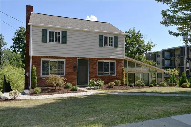 a front view of a house with a yard and a garage