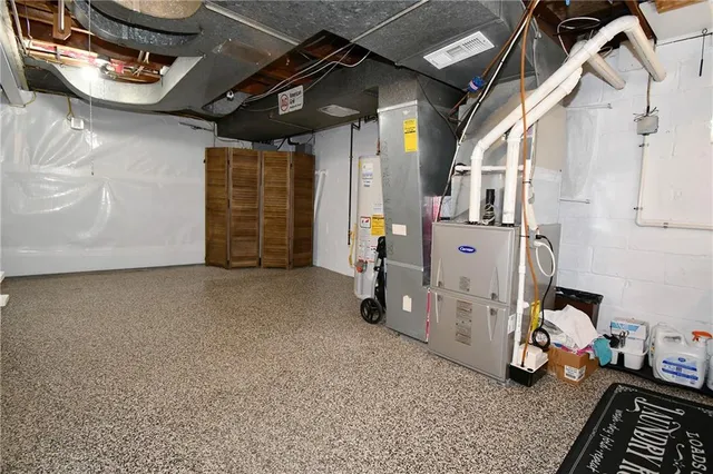 a view of a house with a yard and large tree