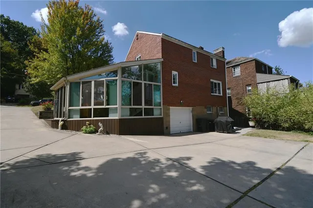 a view of a yard with plants and trees