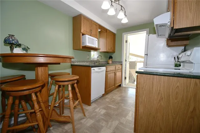 a kitchen with a sink a stove and cabinets