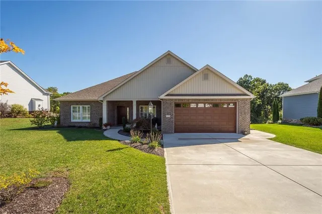 a front view of house with yard and outdoor seating