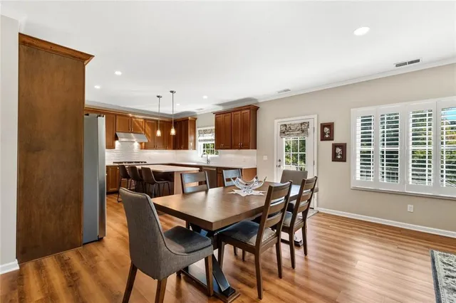 a view of a dining room with furniture and wooden floor