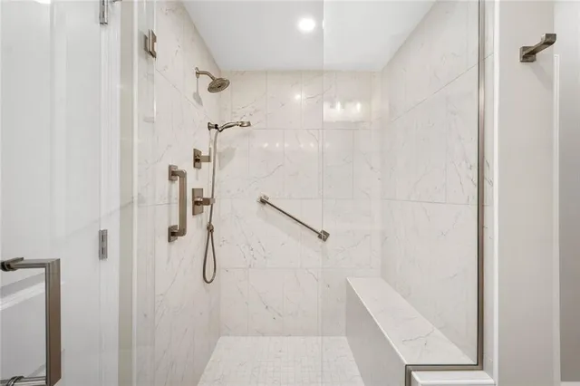a bathroom with a glass shower door