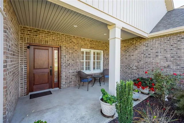a view of a patio with table and chairs and potted plants