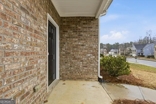 a view of a brick house with an outdoor space