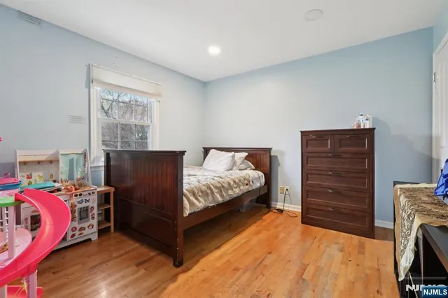 a bedroom with a bed and a tv