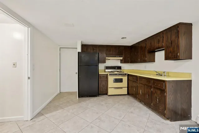 a kitchen with stainless steel appliances a refrigerator and a stove top oven