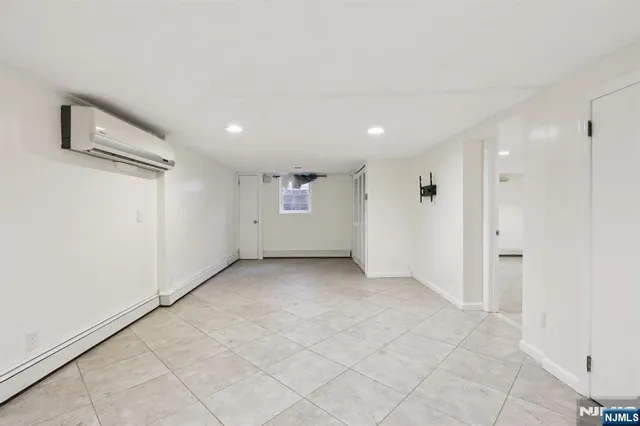 an empty room with a empty space and windows