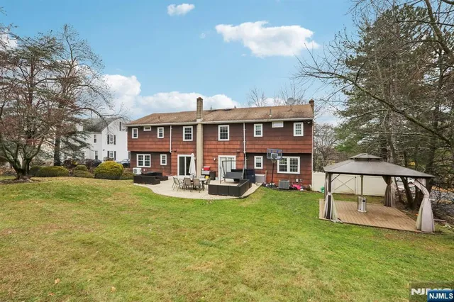 a view of a house with backyard porch and sitting area