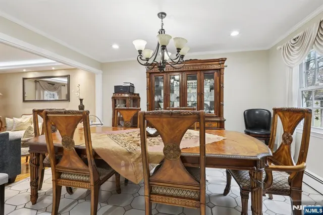 a view of a dining room with furniture and chandelier