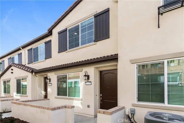 a front view of a house with large windows