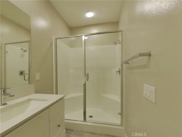 a bathroom with a shower and a sink