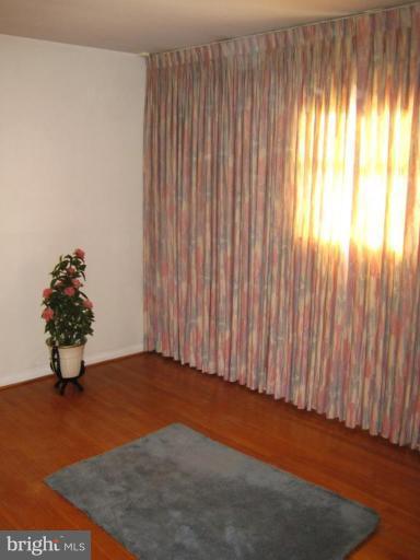7905 Liberty Road Windsor Mill, MD 21244 - Photo 11 of 13 an empty room with wooden floor and windows