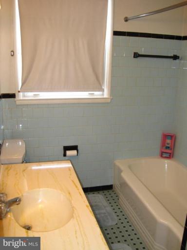 7905 Liberty Road Windsor Mill, MD 21244 - Photo 13 of 13 a bathroom with a bathtub and a window