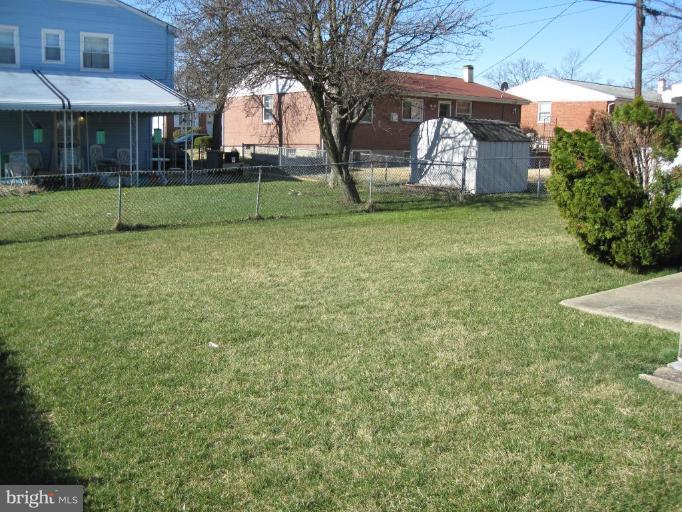 7905 Liberty Road Windsor Mill, MD 21244 - Photo 4 of 13 a backyard of a house with barbeque oven table and chairs