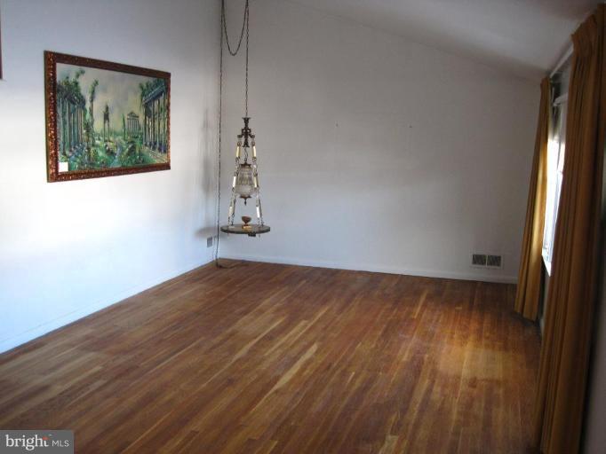 7905 Liberty Road Windsor Mill, MD 21244 - Photo 5 of 13 a view of a room with wooden floor and window