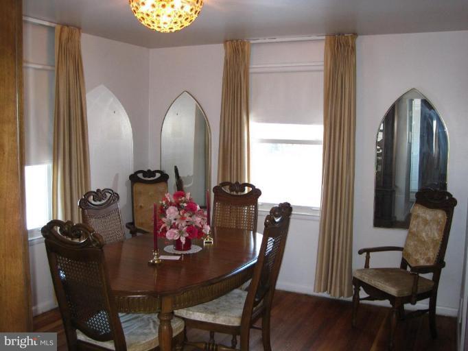7905 Liberty Road Windsor Mill, MD 21244 - Photo 7 of 13 a view of a dining room with furniture and wooden floor