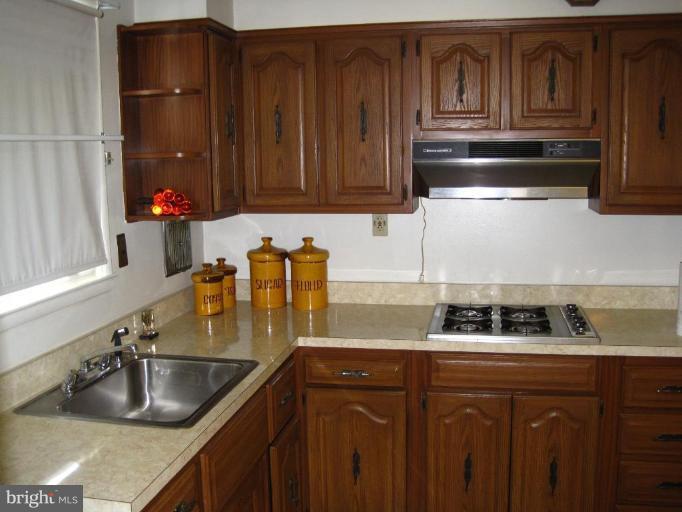 7905 Liberty Road Windsor Mill, MD 21244 - Photo 8 of 13 a kitchen with granite countertop a sink and cabinets