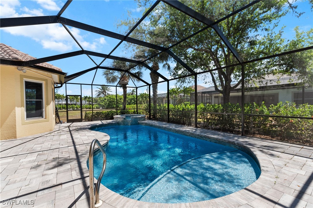 16119 Coco Hammock Way Fort Myers, FL 33908 - Photo 1 of 47 a swimming pool with yard outdoor seating and yard in the back