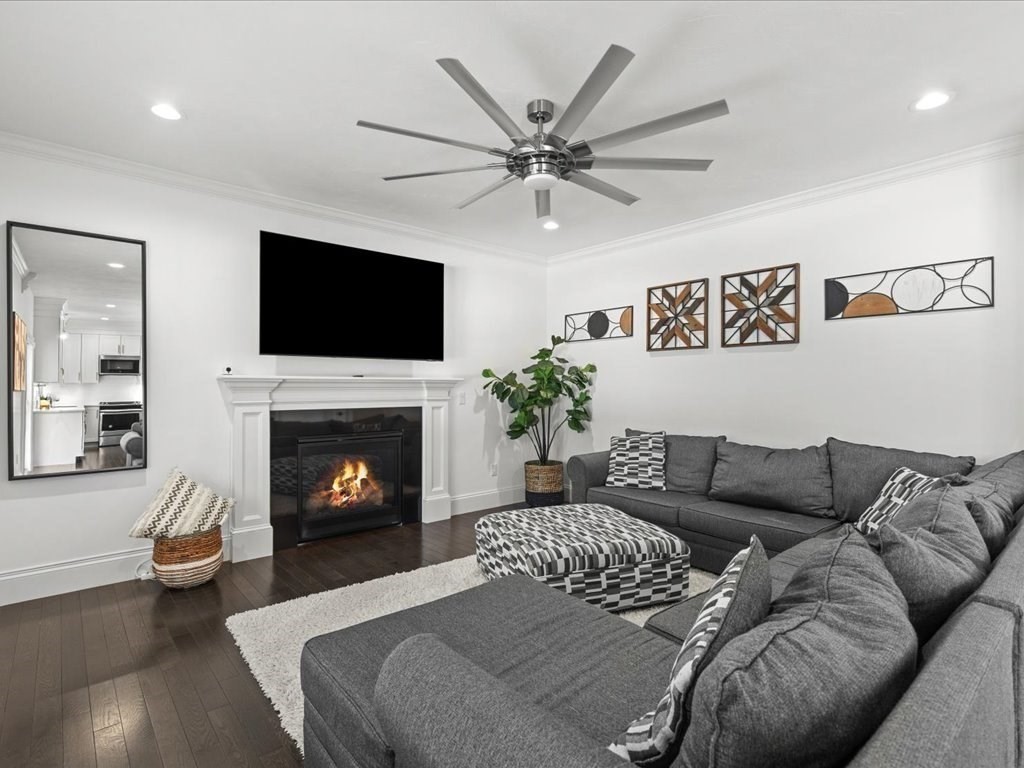 5 Greenbriar Lane Bellingham, MA 02019 - Photo 5 of 26 a living room with furniture a flat screen tv and a fireplace
