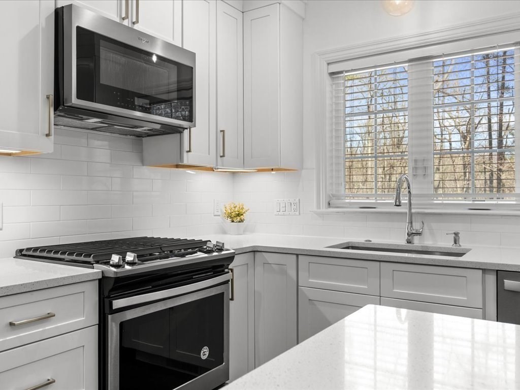 5 Greenbriar Lane Bellingham, MA 02019 - Photo 10 of 26 a kitchen with stainless steel appliances a stove a microwave and sink