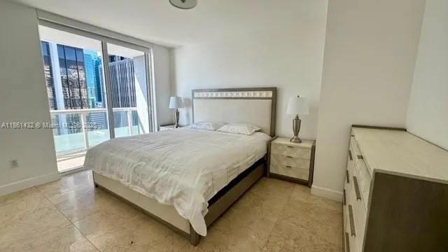 a spacious bathroom with a tub sink and mirror