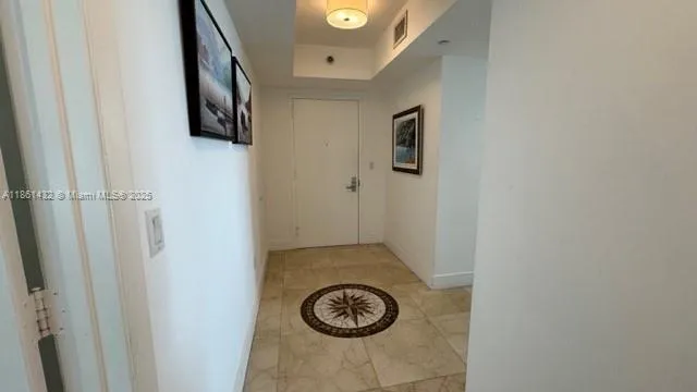 a dining table with chairs and cabinets