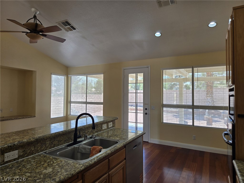 8417 San Ramon Drive Las Vegas, NV 89147 - Photo 13 of 33 A well-appointed kitchen features rich hardwood flooring, granite countertops, and abundant natural light.