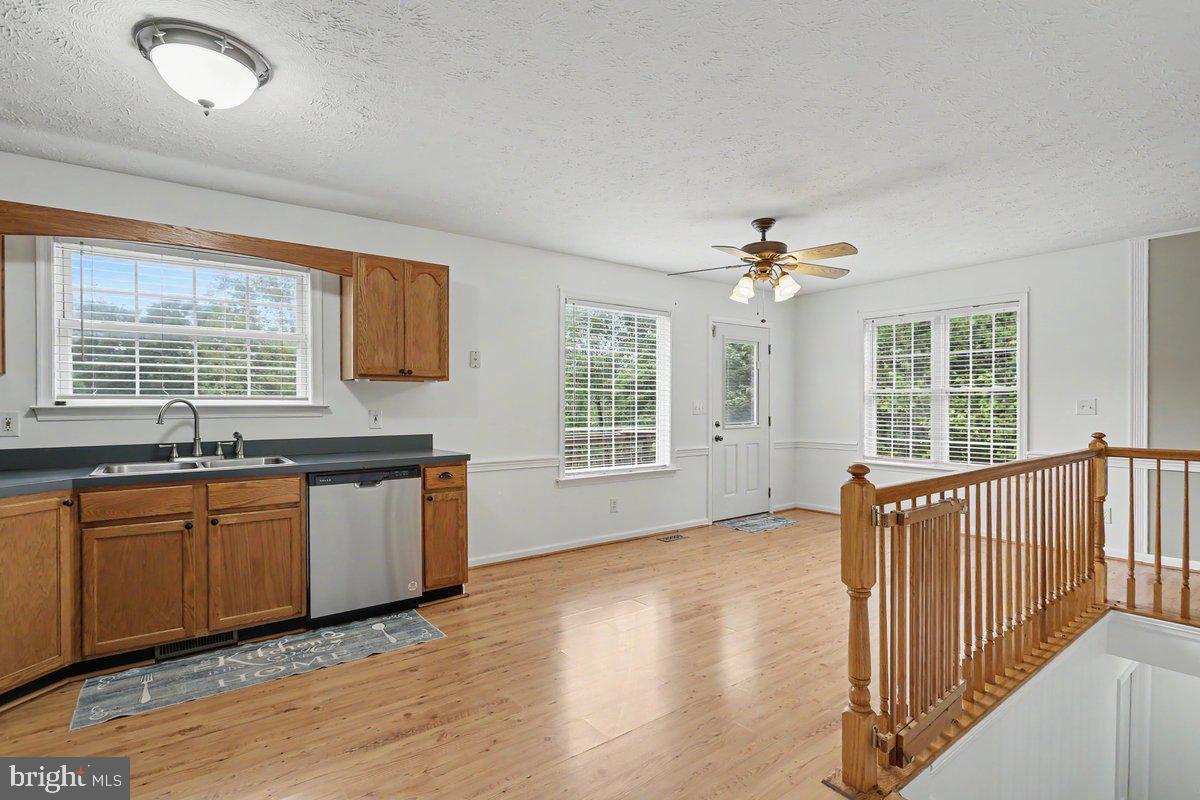 543 Whiskey Still Road Linden, VA 22642 - Photo 12 of 23 a view of a kitchen with granite countertop a sink and dishwasher with wooden floor