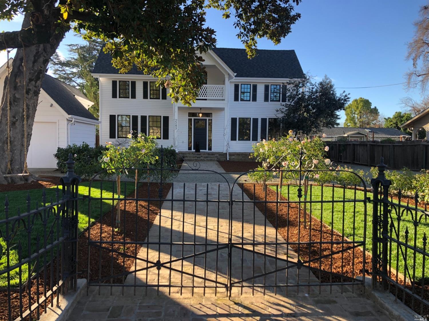 a view of a house with a iron fence