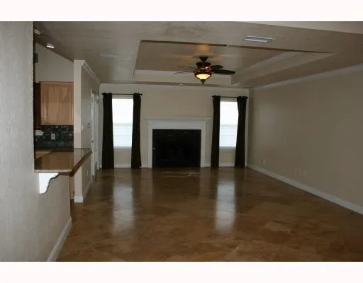 a view of a livingroom with a fireplace a chandelier and stairs