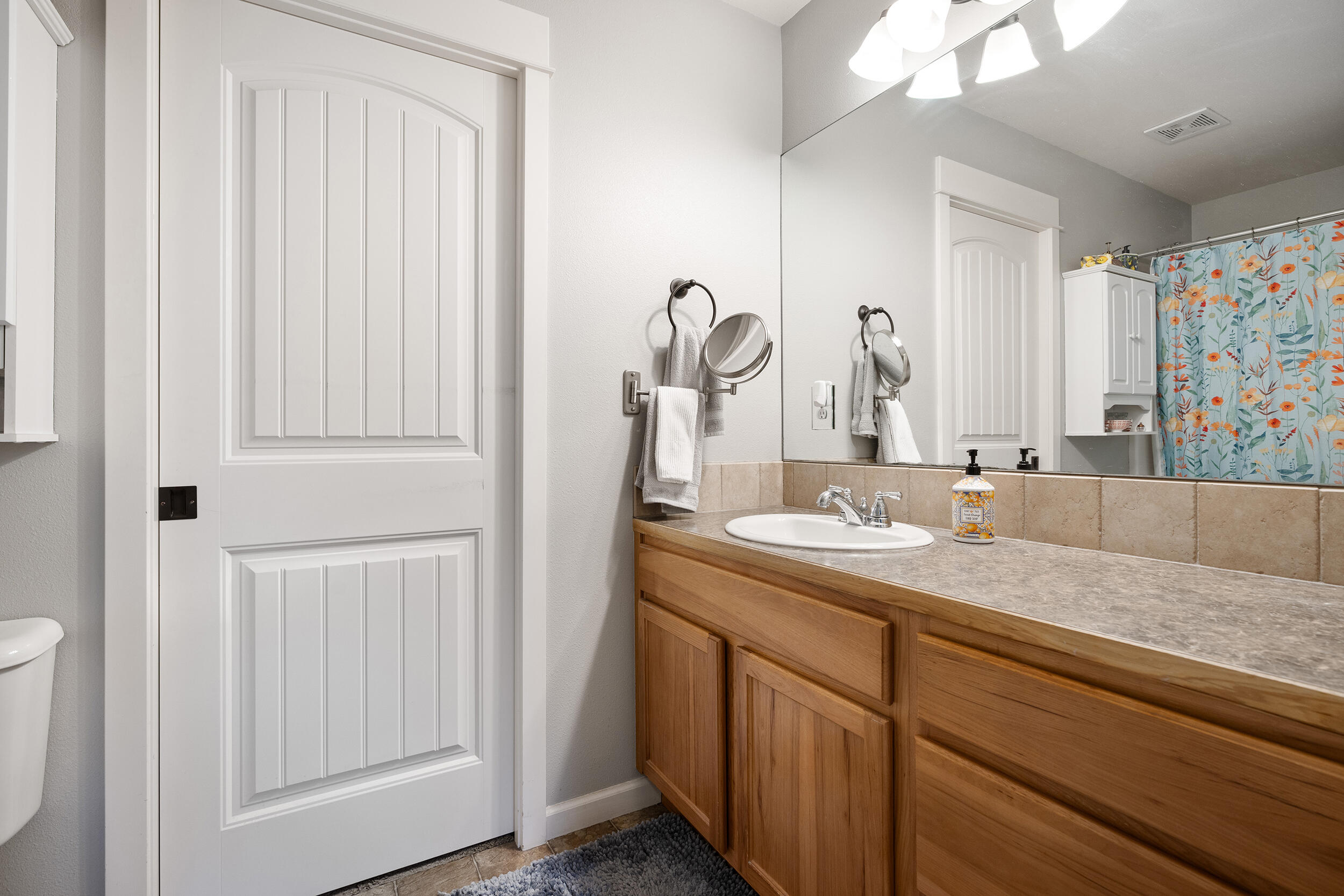 62906 Bilyeu Way Bend, OR 97701 - Photo 66 of 100 a bathroom with a granite countertop sink and a mirror