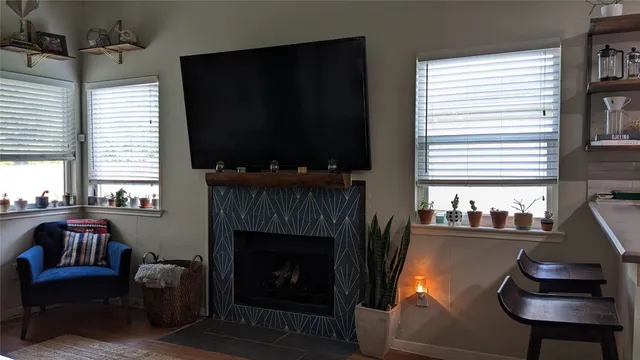 a living room with furniture a flat screen tv and a fireplace