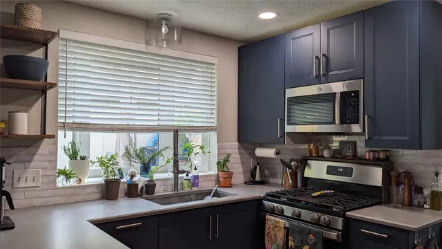 a kitchen with a stove a sink and a microwave