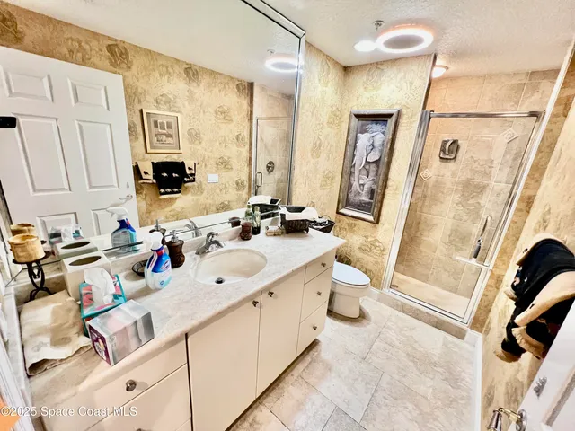 a bathroom with a double vanity sink a mirror and a bathtub