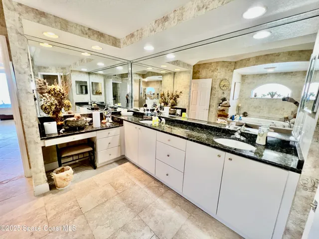 a large white kitchen with a large window