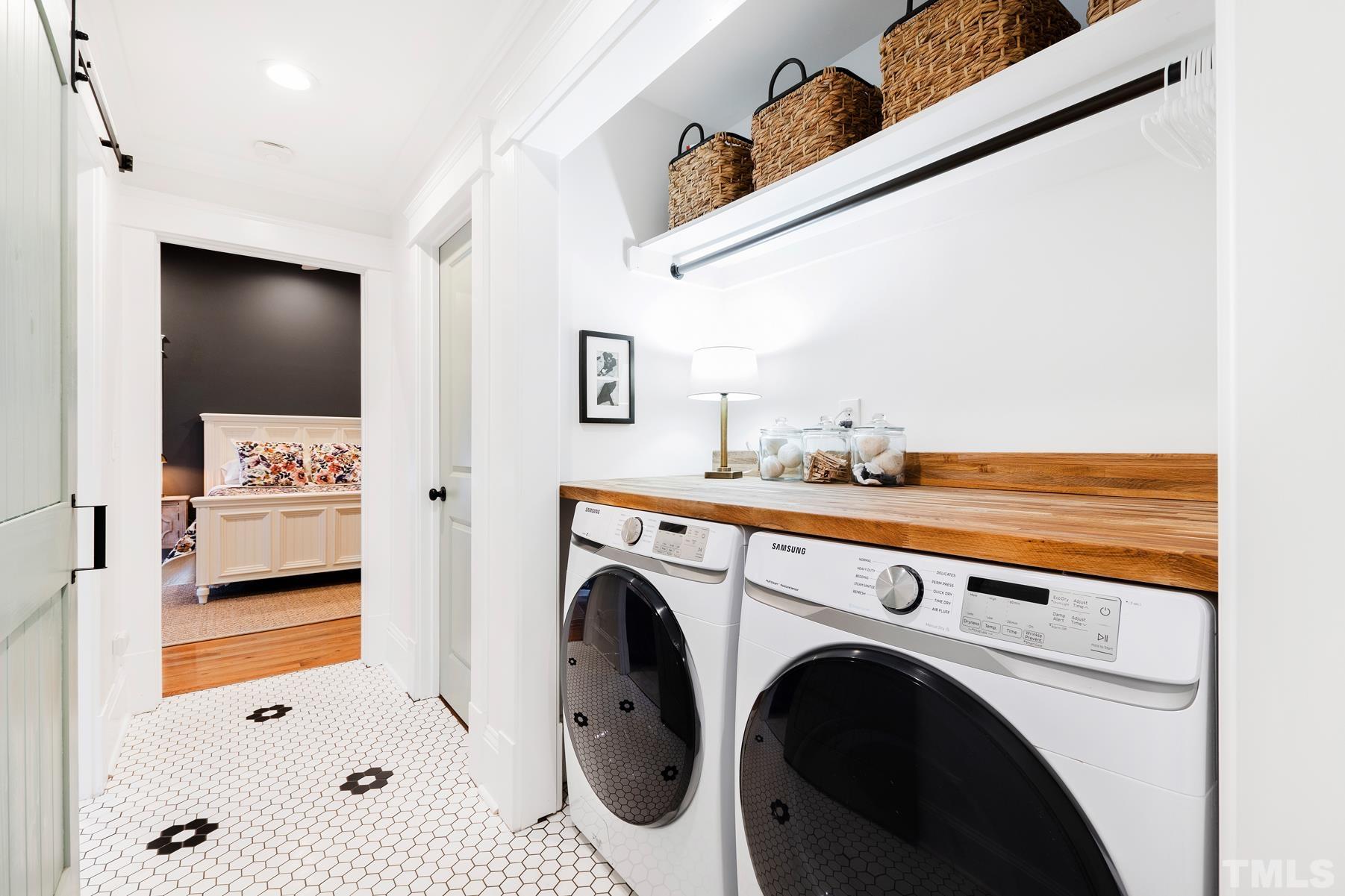 308 Perry Street Raleigh, NC 27608 - Photo 21 of 30 a view of washer and dryer with kitchen in the background