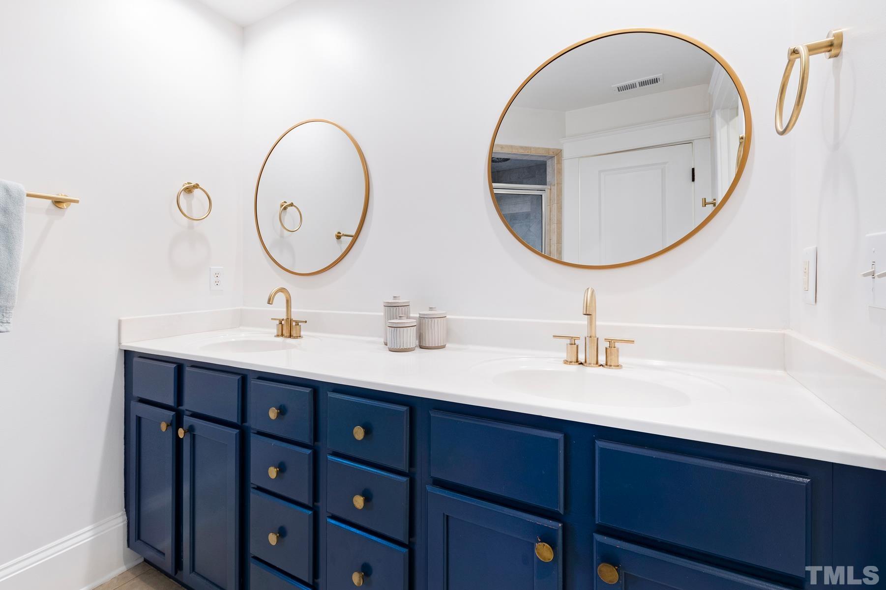 308 Perry Street Raleigh, NC 27608 - Photo 25 of 30 a bathroom with a double vanity sink and a mirror