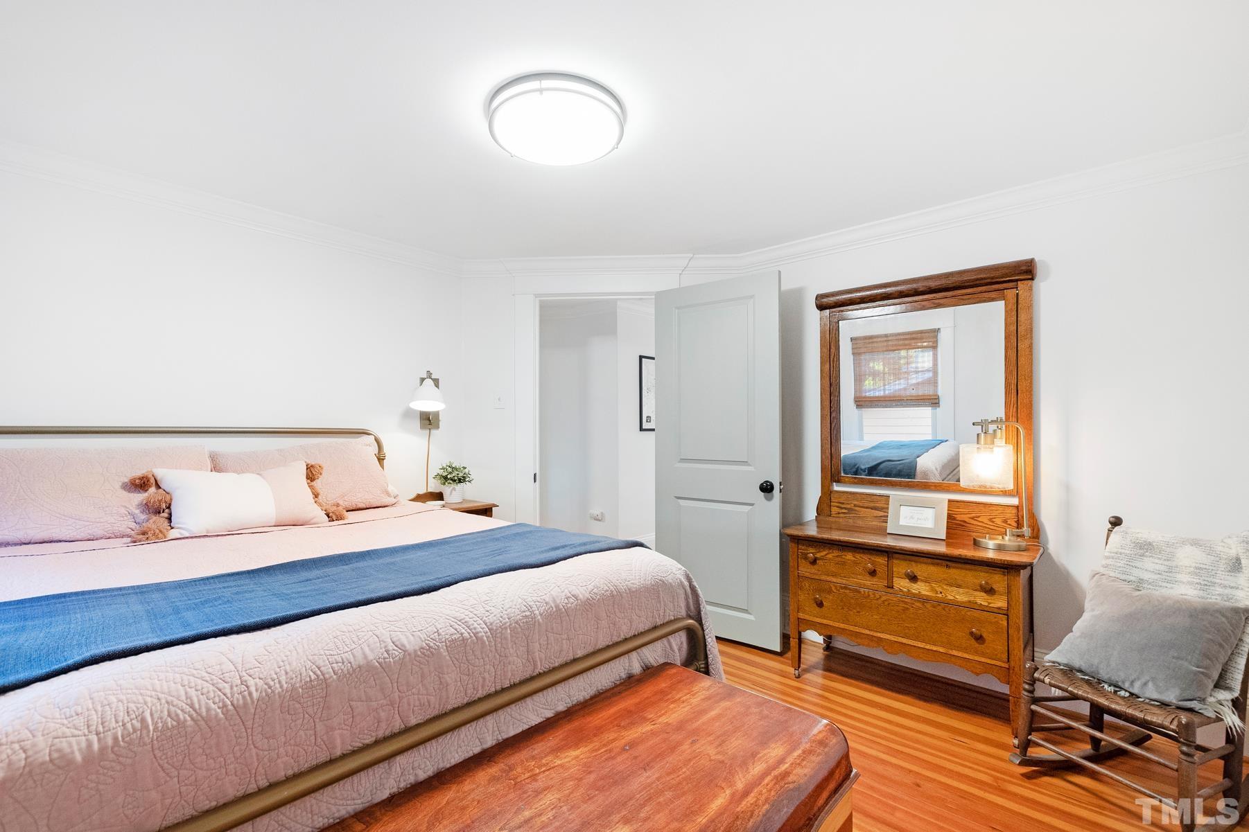 308 Perry Street Raleigh, NC 27608 - Photo 27 of 30 a bedroom with a bed and a dresser