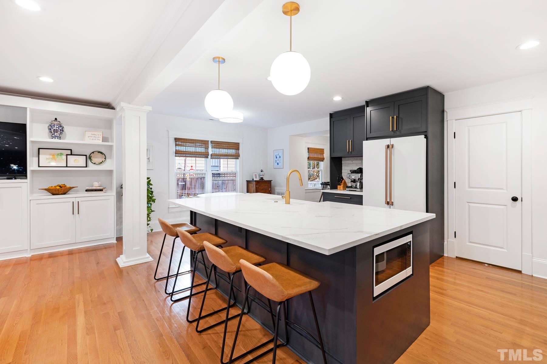 308 Perry Street Raleigh, NC 27608 - Photo 10 of 30 a kitchen that has a table chairs and wooden floor