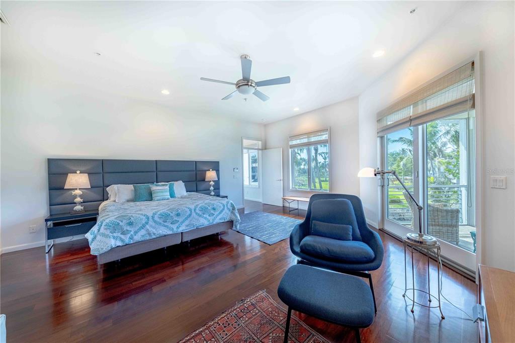 16250 Sunset Pines Circle Boca Grande, FL 33921 - Photo 19 of 48 a bedroom with a bed and wooden floor
