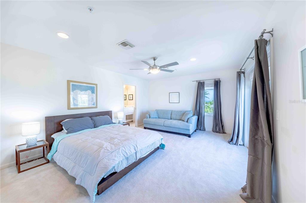 16250 Sunset Pines Circle Boca Grande, FL 33921 - Photo 26 of 48 a bedroom with a bed couch and a window