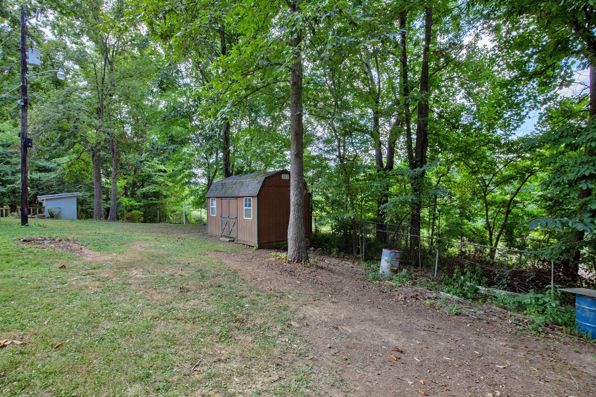 7498 Swift Road Greenbrier, TN 37073 - Photo 54 of 69 a backyard of a house with a trees and plants