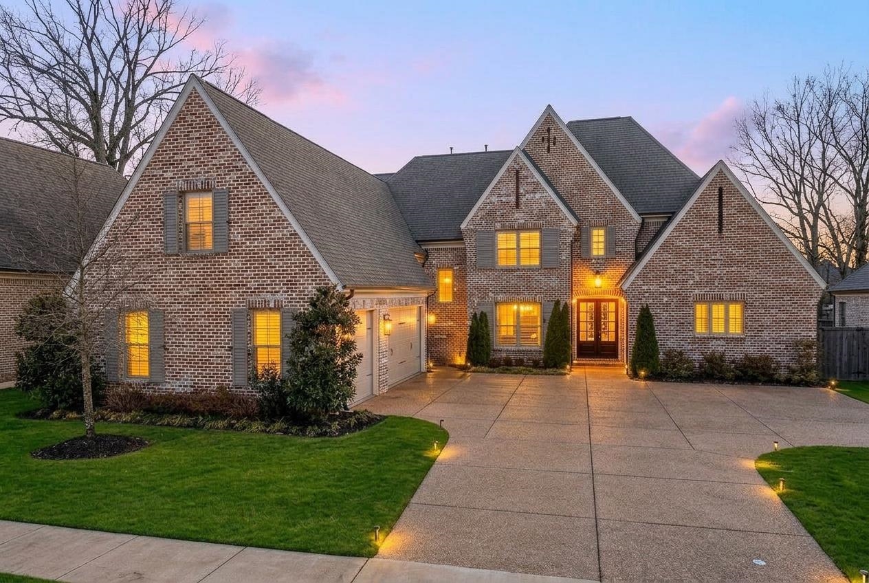 4757 Carousel Lane Collierville, TN 38017 - Photo 1 of 39 Brick exterior featuring multiple gables, a multi-pane front door, and an attached two-car garage