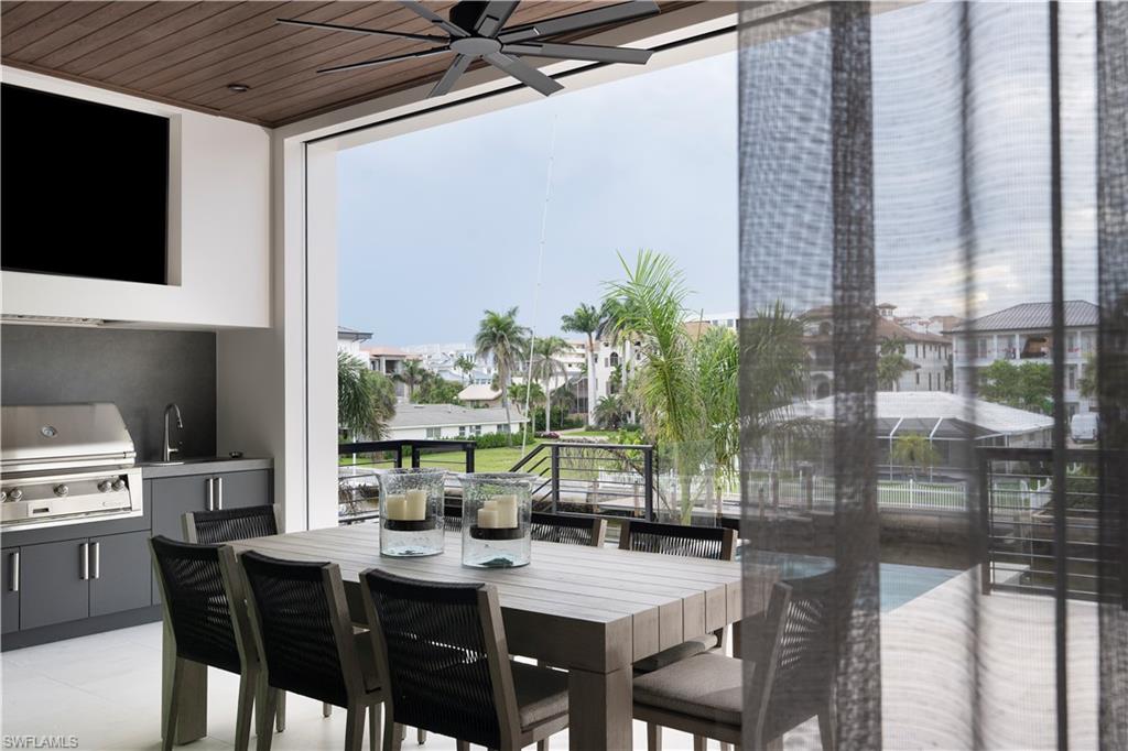 141 Channel Drive Naples, FL 34108 - Photo 13 of 28 Dining area featuring a ceiling fan, healthy amount of natural light, and wooden ceiling