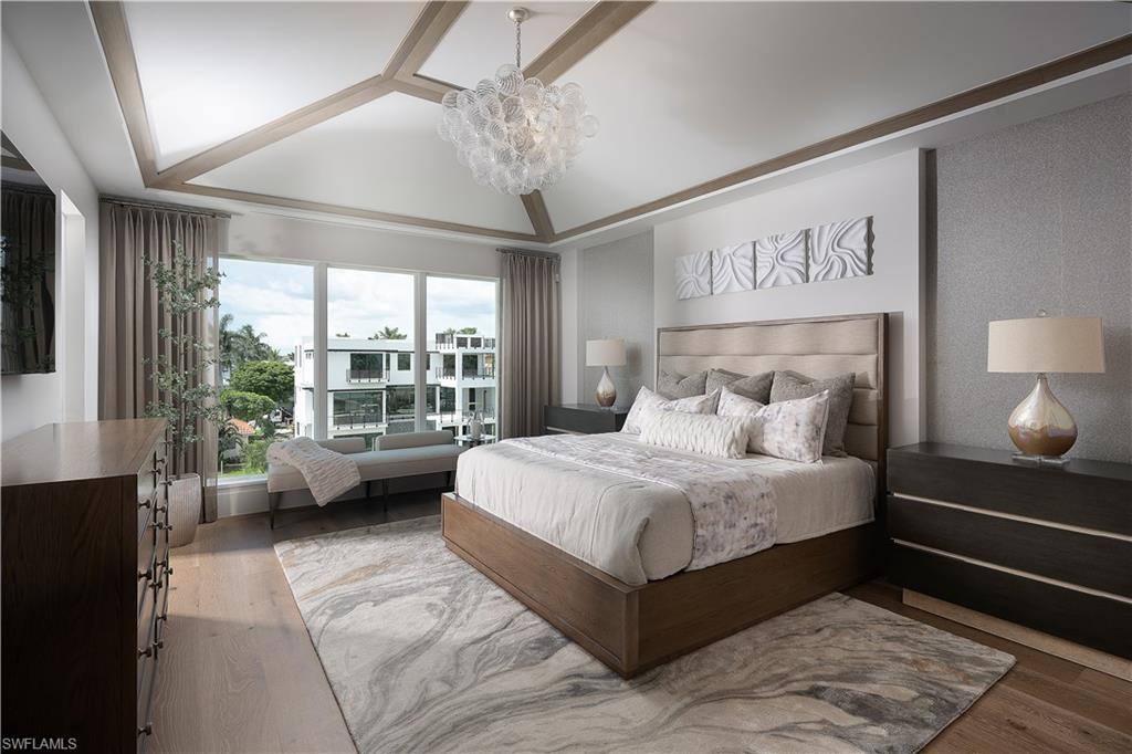 141 Channel Drive Naples, FL 34108 - Photo 17 of 28 Bedroom with a chandelier and wood finished floors