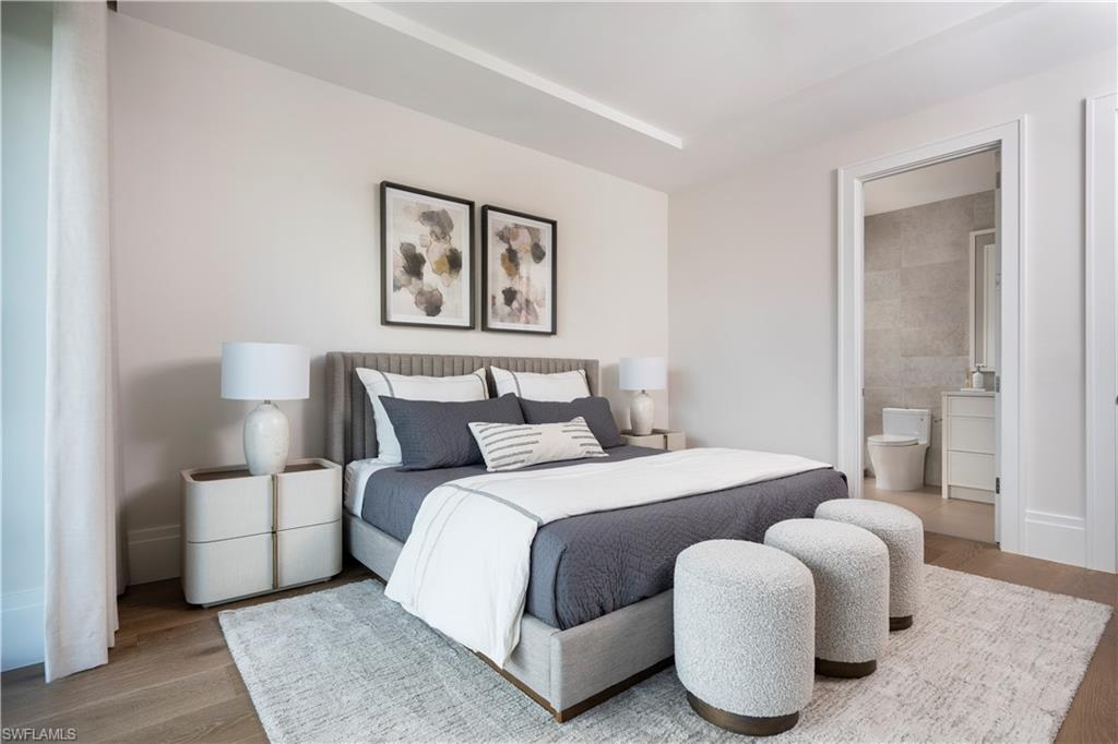 141 Channel Drive Naples, FL 34108 - Photo 21 of 28 Bedroom featuring wood finished floors and connected bathroom